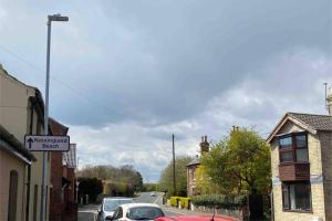 a street with cars parked on the side of a road at 1st Floor Flat in Mews in Kessingland