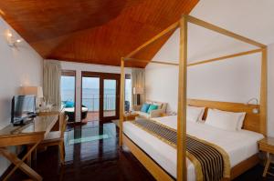 a bedroom with a bed and a desk and a bed and a computer at Embudu Village Maldives in South Male Atoll +76 photos