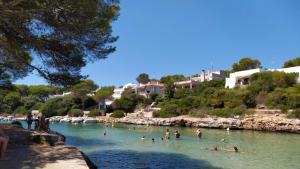 a group of people swimming in a river at Villa Sirena in Cala en Blanes