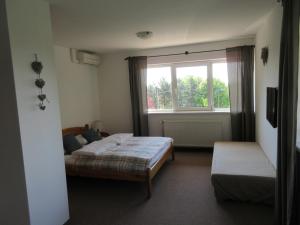 A bed or beds in a room at Mediterrán Vendégház