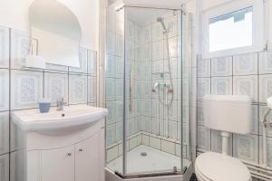 a bathroom with a shower and a toilet and a sink at Casa Elia in Bran +42 photos