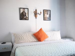 1 dormitorio con 1 cama con 3 cuadros en la pared en Alonso53, en Guanajuato