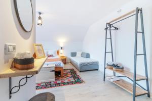 a room with a bed and a mirror and a ladder at Casa Elia in Bran