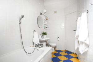 a white bathroom with a shower and a sink at Hugo in Władysławowo