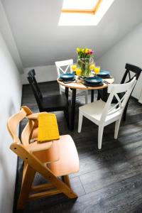 a dining room with a table and chairs at Hugo in Władysławowo +11 photos