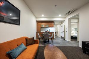 a living room with a couch and a table at Galaxy Boutique Hotel in Lake Tekapo