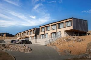 a building with a car parked in front of it at Galaxy Boutique Hotel in Lake Tekapo