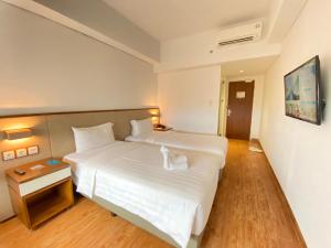 Cama o camas de una habitación en Grand Zuri Ketapang