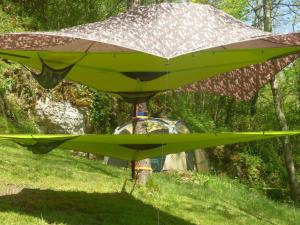 a green airplane sitting on top of a field at dtente sky lodge in Massat