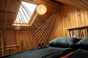 a bedroom with a hammock bed and a window at Casa Petri Rosia Montana in Roşia Montană