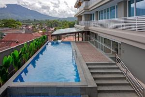 a swimming pool on the balcony of a building at Hotel Santika Bukittinggi in Bukittinggi