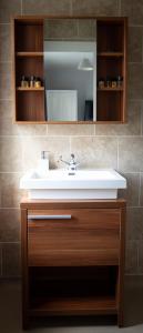 a bathroom with a sink and a mirror at The Sun Inn At Hook Norton in Banbury