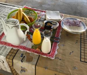 a table topped with milk and a bowl of food at LCC rooms in Couço