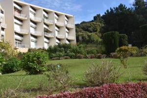 a hotel with a garden in front of a building at PORTICCIO BRILOC APPART DUPLEX à 150m de la plage. in Porticcio +2 photos