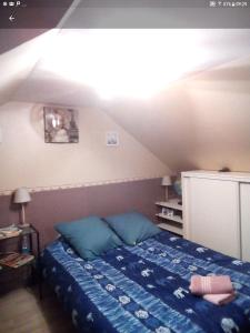 a bedroom with a bed in a attic at les vignes d'Ygrande in Ygrande