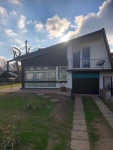 a large house with a garage in a yard at duunn koksijde in Koksijde