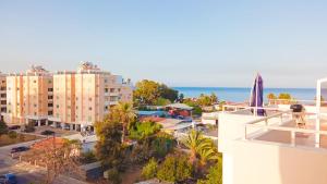a view of the ocean from the balcony of a building at Luxury private rooms -SEA VIEW, NETFLIX, GYM- 5 Min from beach! - private room in shared apartment in Larnaca