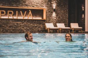 a woman in a bathing suit in a swimming pool at PRIVÀ Alpine Lodge in Lenzerheide