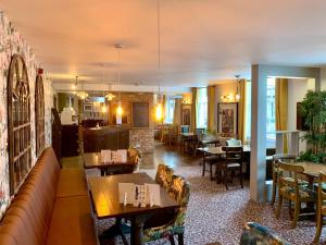 a restaurant with couches and tables and chairs at The Crown Hotel in Hailsham