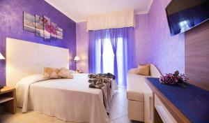 Postel nebo postele na pokoji v ubytování Hotel Petronio