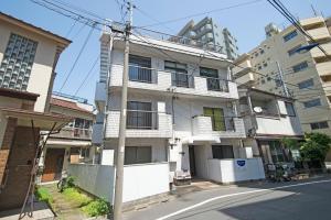 an apartment building on a city street at Oji Natural Cosy House in Tokyo