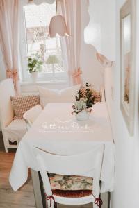 a white table with a white table cloth on it at Ferienwohnung "Gott sei Dank" in Herzberg am Harz