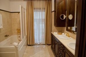 a bathroom with a tub and a sink and a bath tub at Hotel Casa Capsa in Bucharest +78 photos