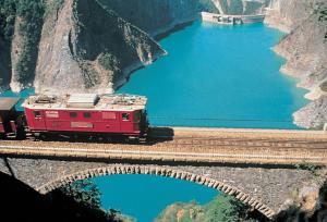 a train on a bridge over a body of water at Studio des alpes in La Mure