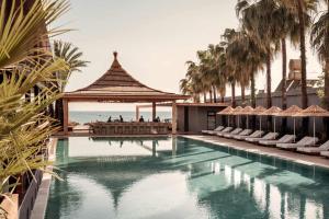a swimming pool with a gazebo and palm trees at ananea Kleopatra Beach - Adults Only 12 in Alanya