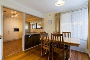 a kitchen and dining room with a table and chairs at The Greenery in Castlemaine