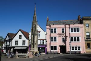 a street in a town with a church tower at The Crown Hotel in Glastonbury