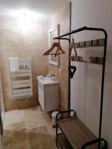 a small bathroom with a sink and a toilet at Appartement PERIGUEUX Garage attenant Fibre Climatisation in Périgueux +2 photos