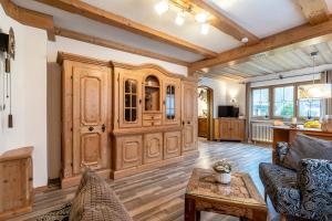 a living room with wooden cabinets and a table at Ferienwohnung Anna in Garmisch-Partenkirchen
