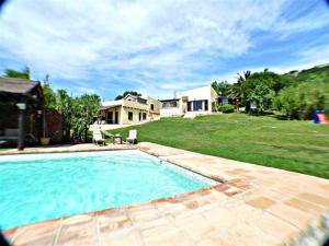 a large swimming pool in front of a house at Villas Ahumada. Chalet La Ahumada in Tarifa