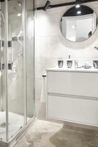 a bathroom with a shower and a sink and a mirror at FERIA MODERN y LUXURY in Seville