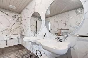 a bathroom with two sinks and a mirror at The Rivulet in Hobart +106 photos