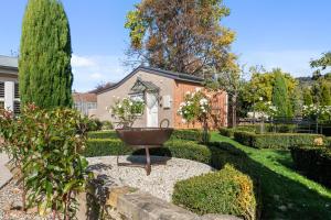 a garden with a fountain in the middle of a yard at The Rivulet in Hobart