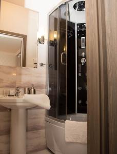 a bathroom with a shower and a sink at Mini ELEGANT in Kyiv