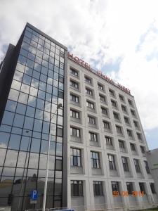 a large white building with a lot of windows at Hotel Emma West in Craiova