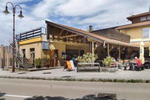 a building with tables and chairs in front of it at Apartment in Siofok - Balaton 19745 in Balatonszabadi Fürdőtelep
