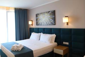 Postel nebo postele na pokoji v ubytování VM Resort & SPA