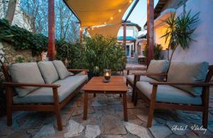two chairs and a coffee table on a patio at Casa de la Mare in Vama Veche +33 photos