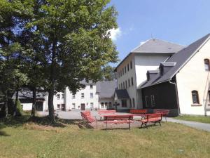 a group of red benches in front of a building at Apartment Sayda 3 in Pilsdorf