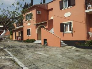 an empty street in front of a building at Villa Loukia in Corfu