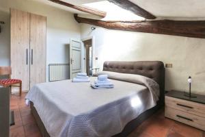 a bedroom with a bed with towels on it at Massimiliano apartment in center with AC in Lucca