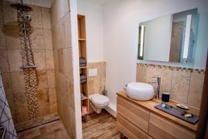 La salle de bains est pourvue d'une douche, de toilettes et d'un lavabo. dans l'établissement Gîte de Léonie Moulin de Tartay en Avignon, à Avignon