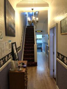 a hallway with a staircase and a stair case at Ultimate Family Guest House in Blackpool