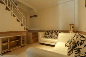 a living room with a couch and a stair case at RedDoorz near Plaza Botania 1 Batam in Batam Center