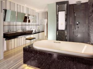 a bathroom with a tub, sink, and bathtub at Swissotel The Bosphorus Istanbul in Istanbul