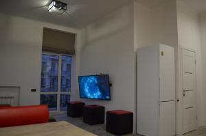 a living room with a flat screen tv on a wall at Arena,VIP in Kyiv